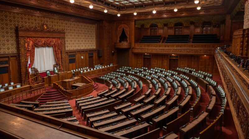 Captivating wide-angle view of a classic legislative assembly hall with ornate wood design.