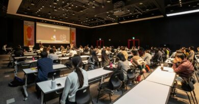 A diverse group attending a conference in a modern hall in Gwangju, South Korea.
