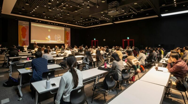 A diverse group attending a conference in a modern hall in Gwangju, South Korea.