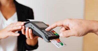 A customer using a contactless payment terminal for secure and cashless transactions indoors.